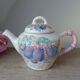 Old ceramic teapot in the shape of a basket of fruits from the garden