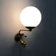 Old pair of wall sconces with carp, brass and globe in white opaline. Year 60