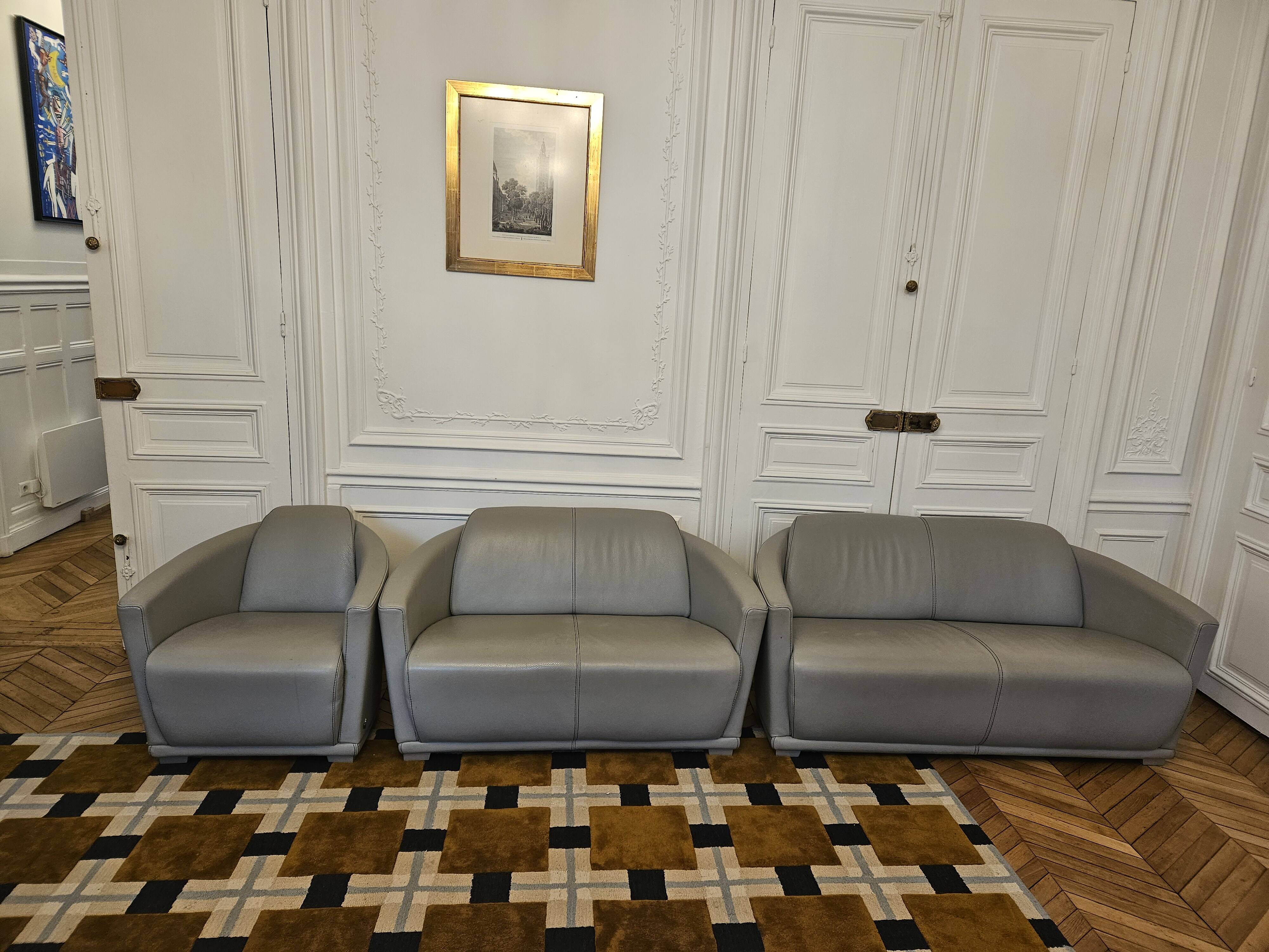 3-seater sofa, 2-seater sofa and an armchair in grey leather by Calia Italia.