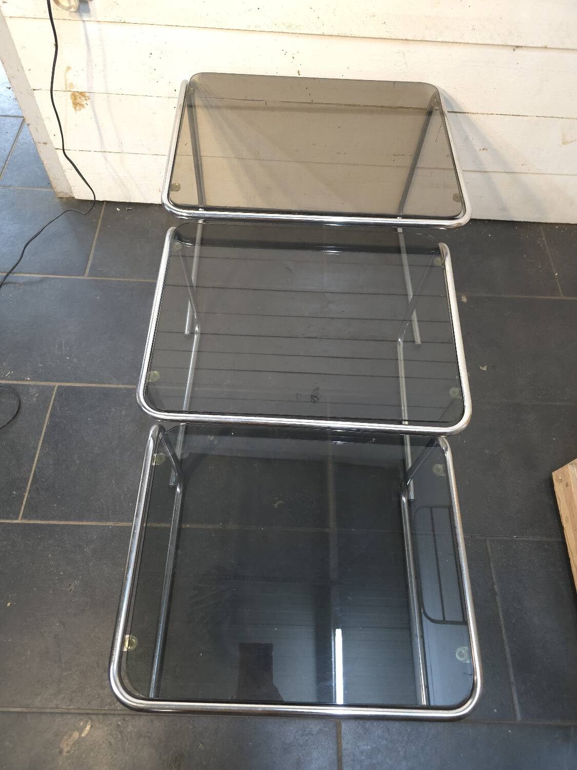 Nesting tables in chromed metal with smoked glass tops from the 1970s