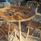 Round dining table Audoux Minet with 4 chairs and 2 armchairs.