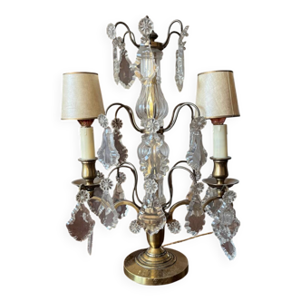 Golden girandole with glass pendants, with two light arms.