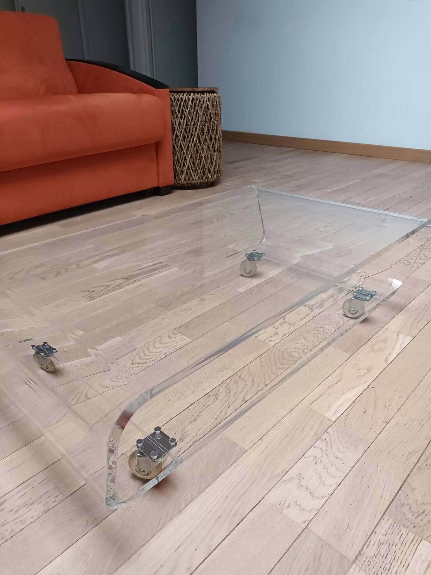 Design coffee table from Habitat in transparent plexiglass, mounted on wheels.