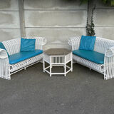 Rattan lounge with two two-seater sofas and a white coffee table.
