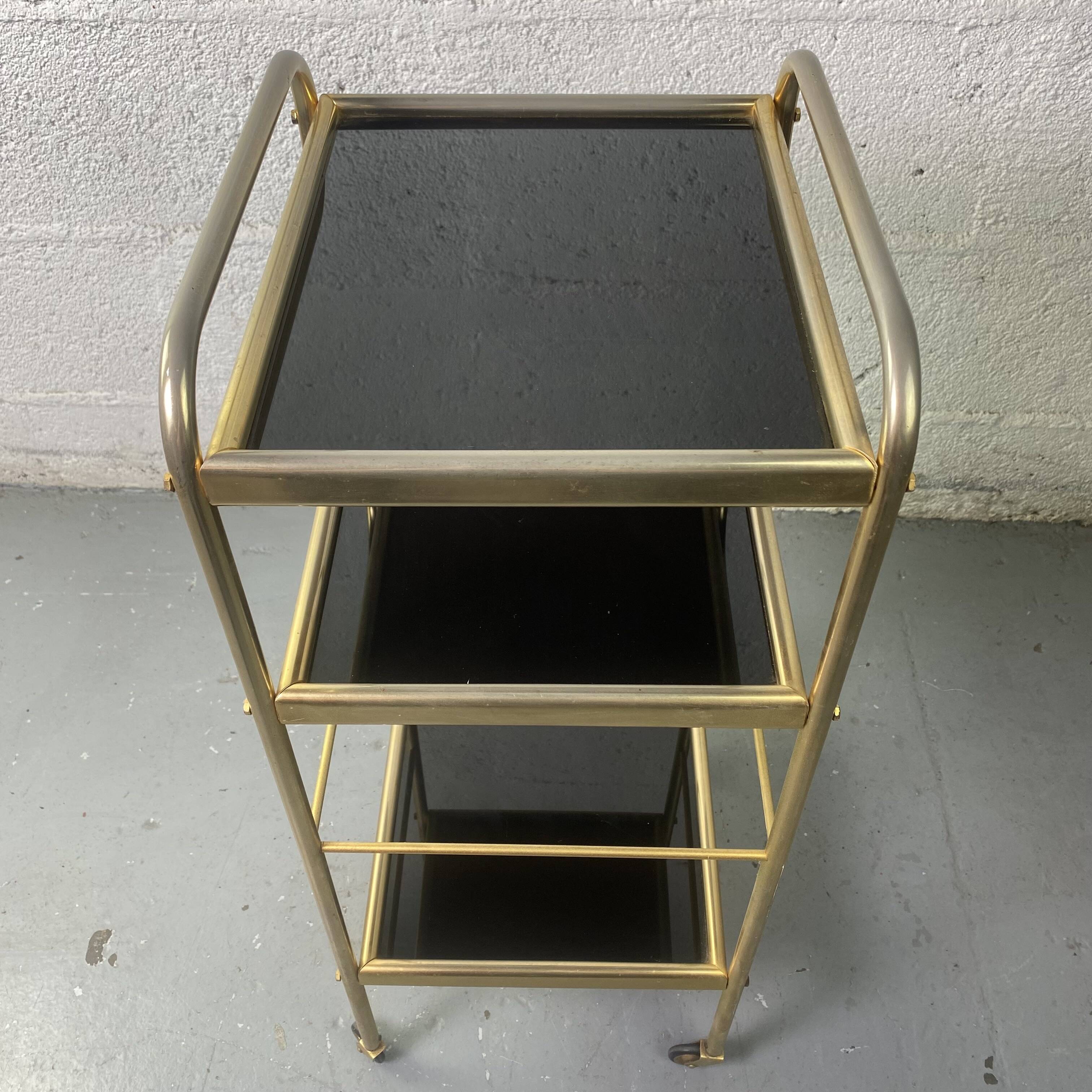 Small rolling trolley in brass and black plastic