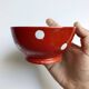 Red bowl with white polka dots in Longchamp ceramic