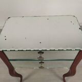 Glass art deco mirror beside table