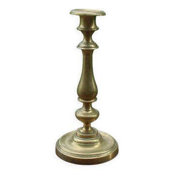 Elegant antique brass candlestick, with a slender silhouette and beautiful turned work.