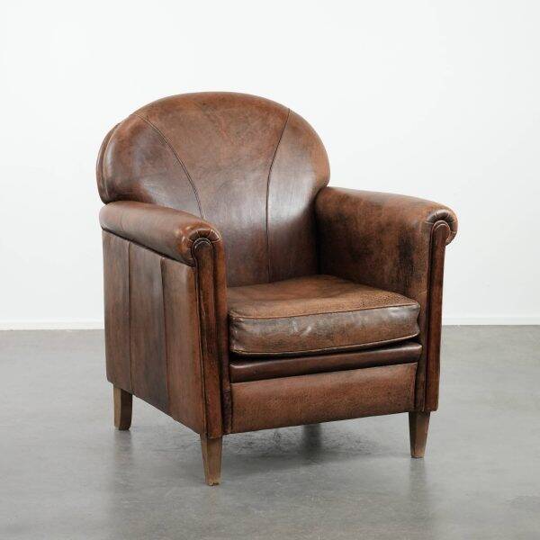 Beautiful vintage sheep leather armchair with a characterful appearance