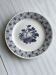 White ceramic plate with a blue fruit pattern.