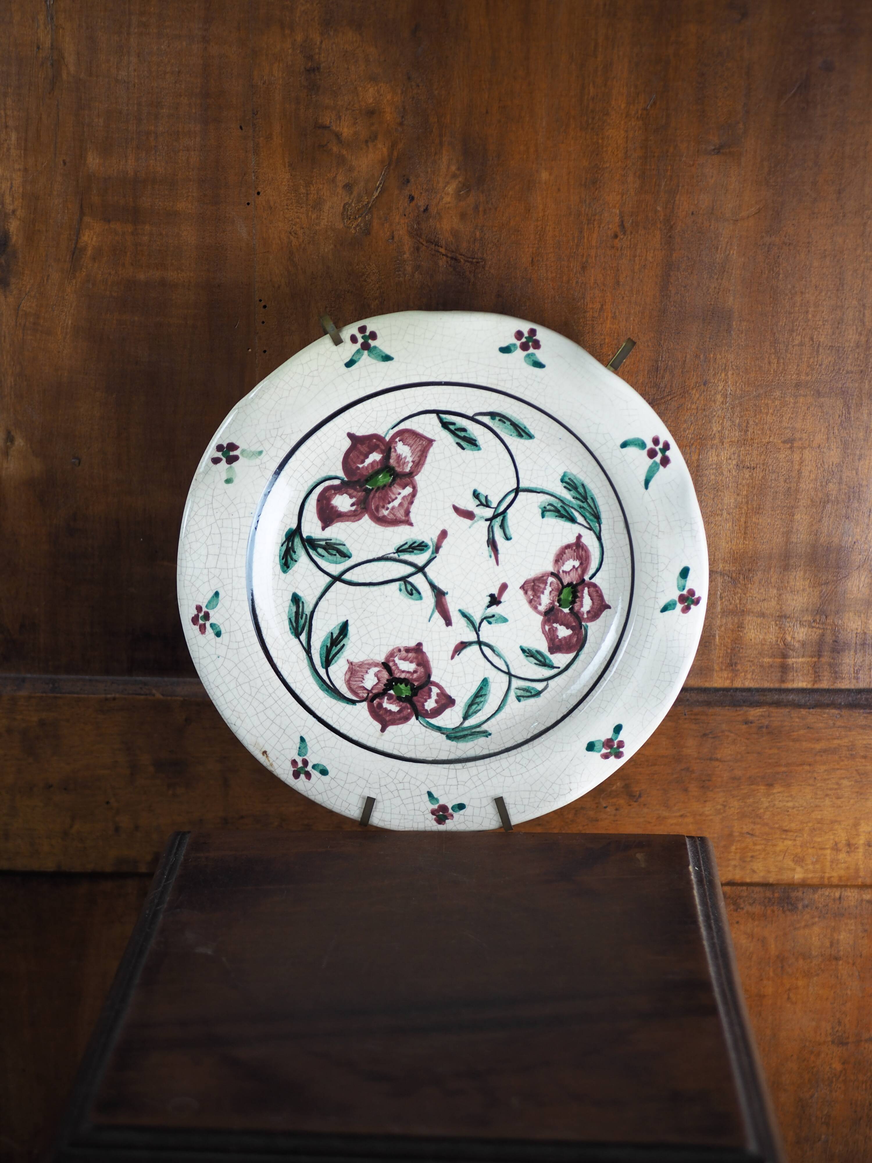 Meyssac plate decorated with flowers on cracked background early twentieth century and its support