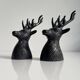 Salt and pepper shaker set with patinated brass deer heads.