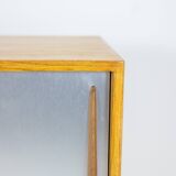 Low ash sideboard with sliding doors. 1960s.
