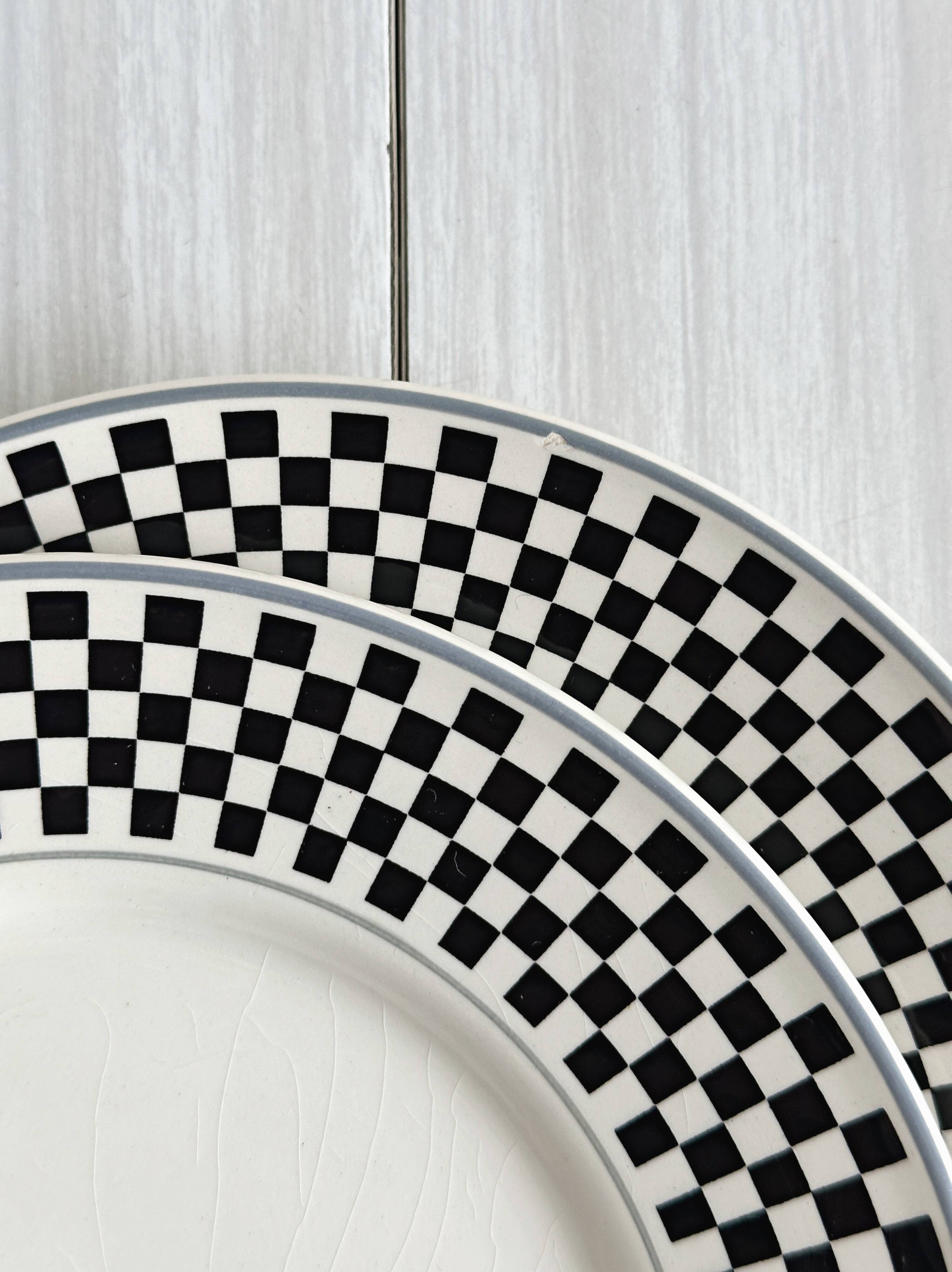 Pair of vintage plates with a black and white checkered pattern.