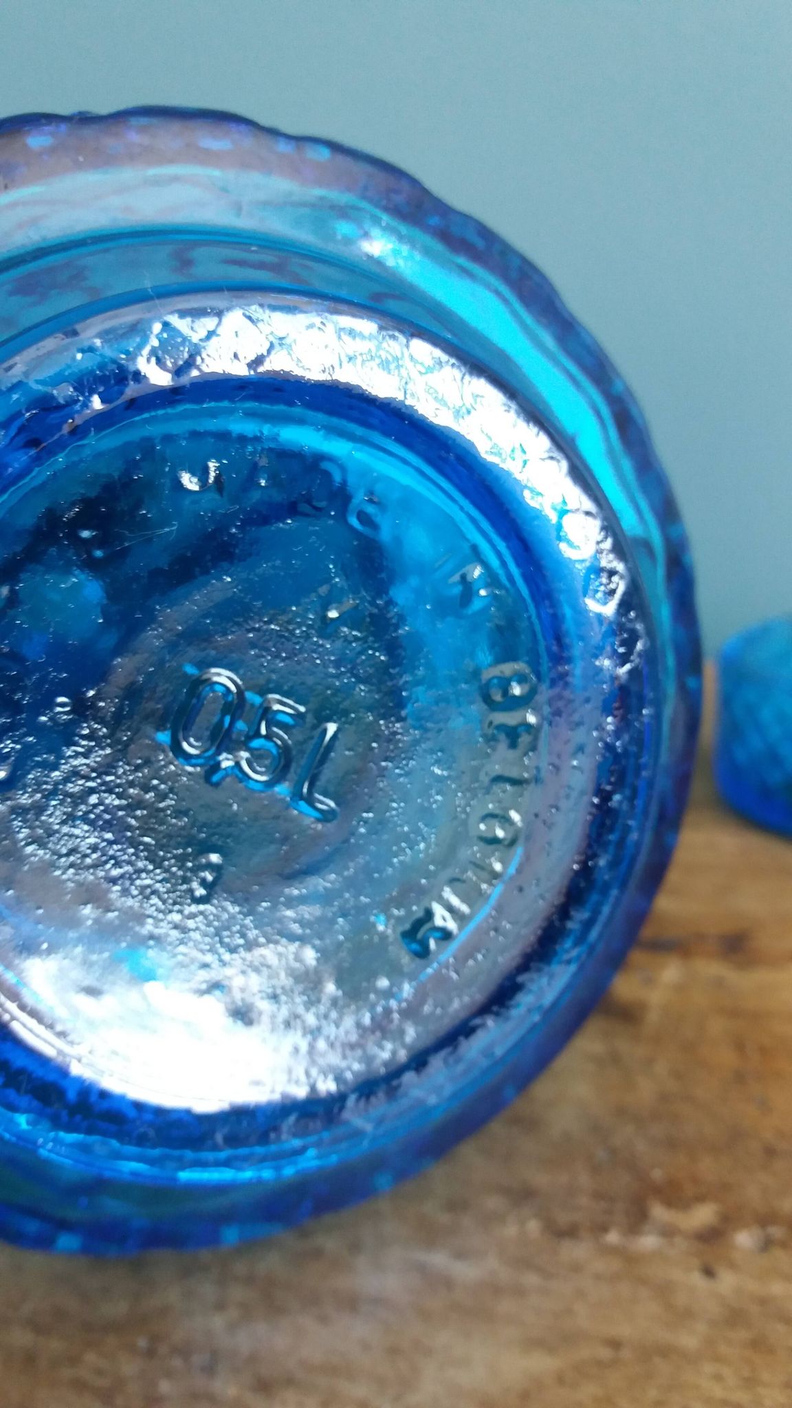 Turquoise glass carafe bottle with a stopper.