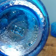 Turquoise glass carafe bottle with a stopper.