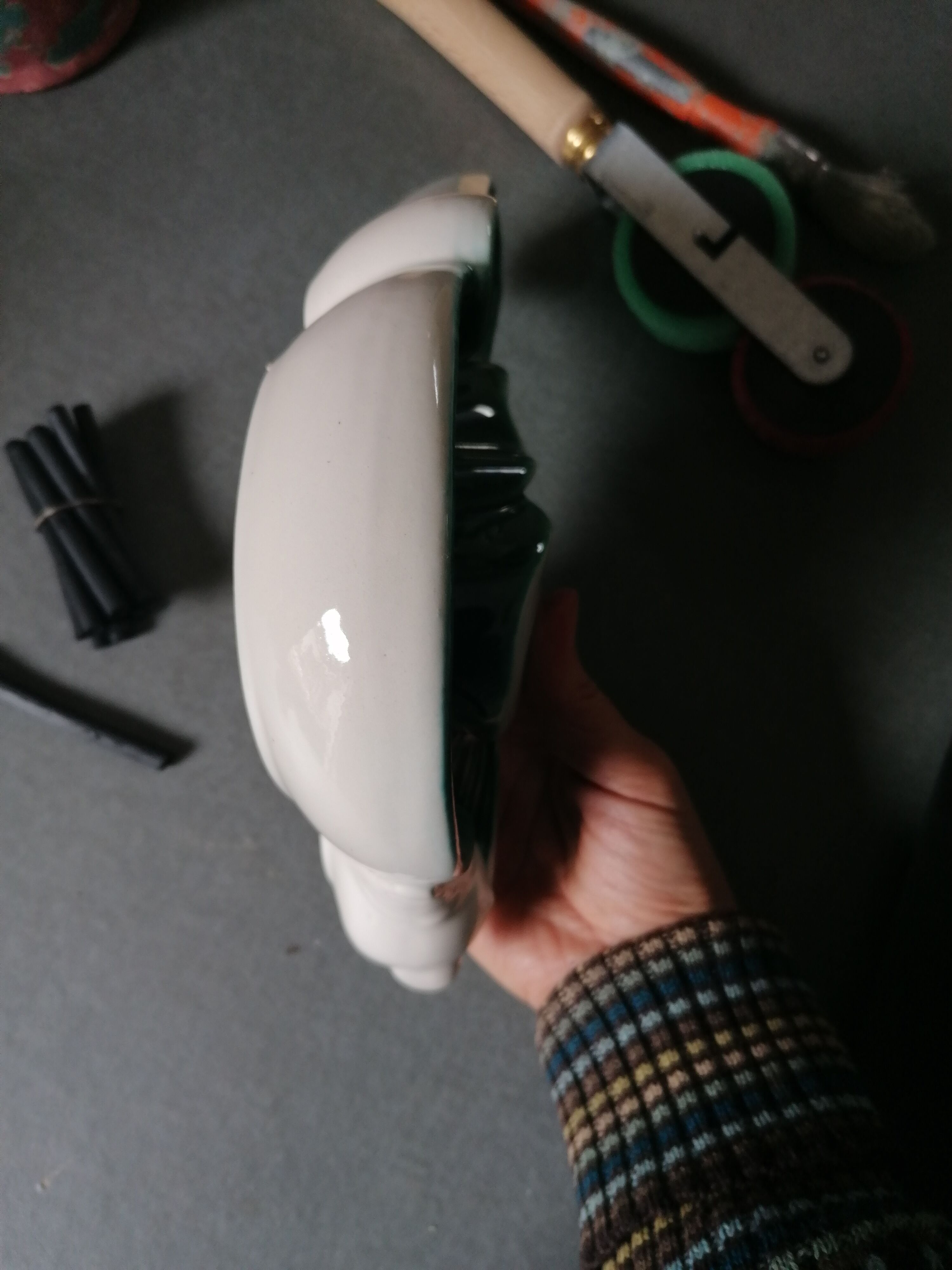 Empty green and white ceramic bird pocket