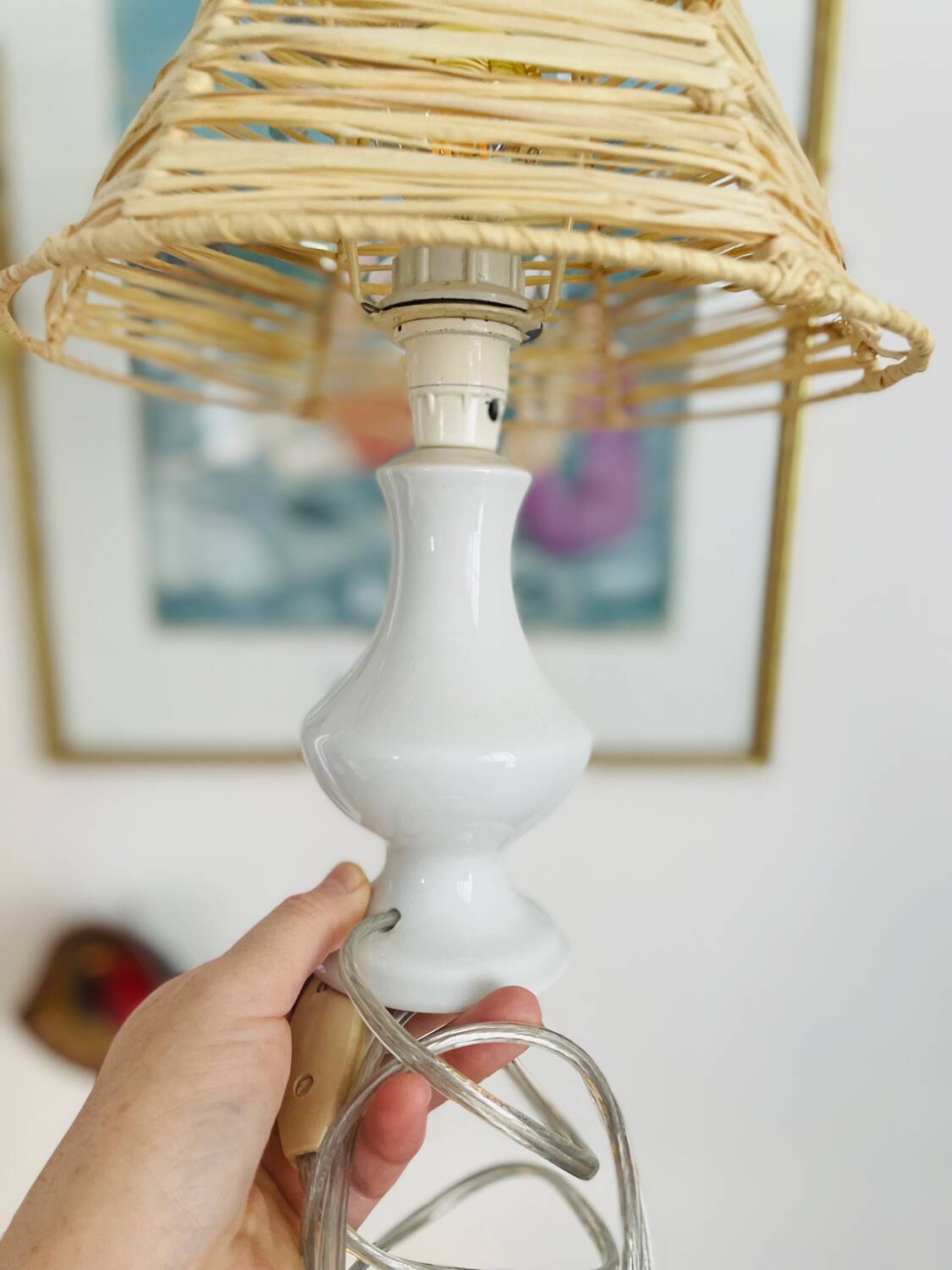 White porcelain table lamp and vintage raffia lampshade