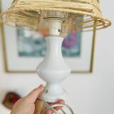White porcelain table lamp and vintage raffia lampshade