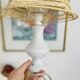 White porcelain table lamp and vintage raffia lampshade