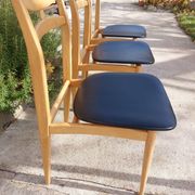 3 Scandinavian style chairs, light wood and black faux leather.
