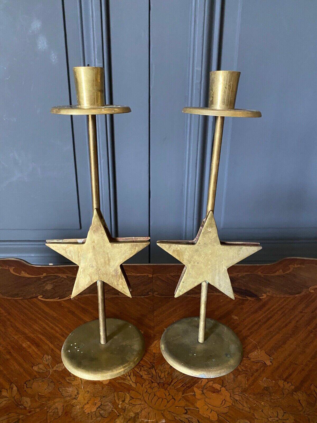 Pair of brass candlesticks decorated with 20th century stars