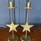 Pair of brass candlesticks decorated with 20th century stars