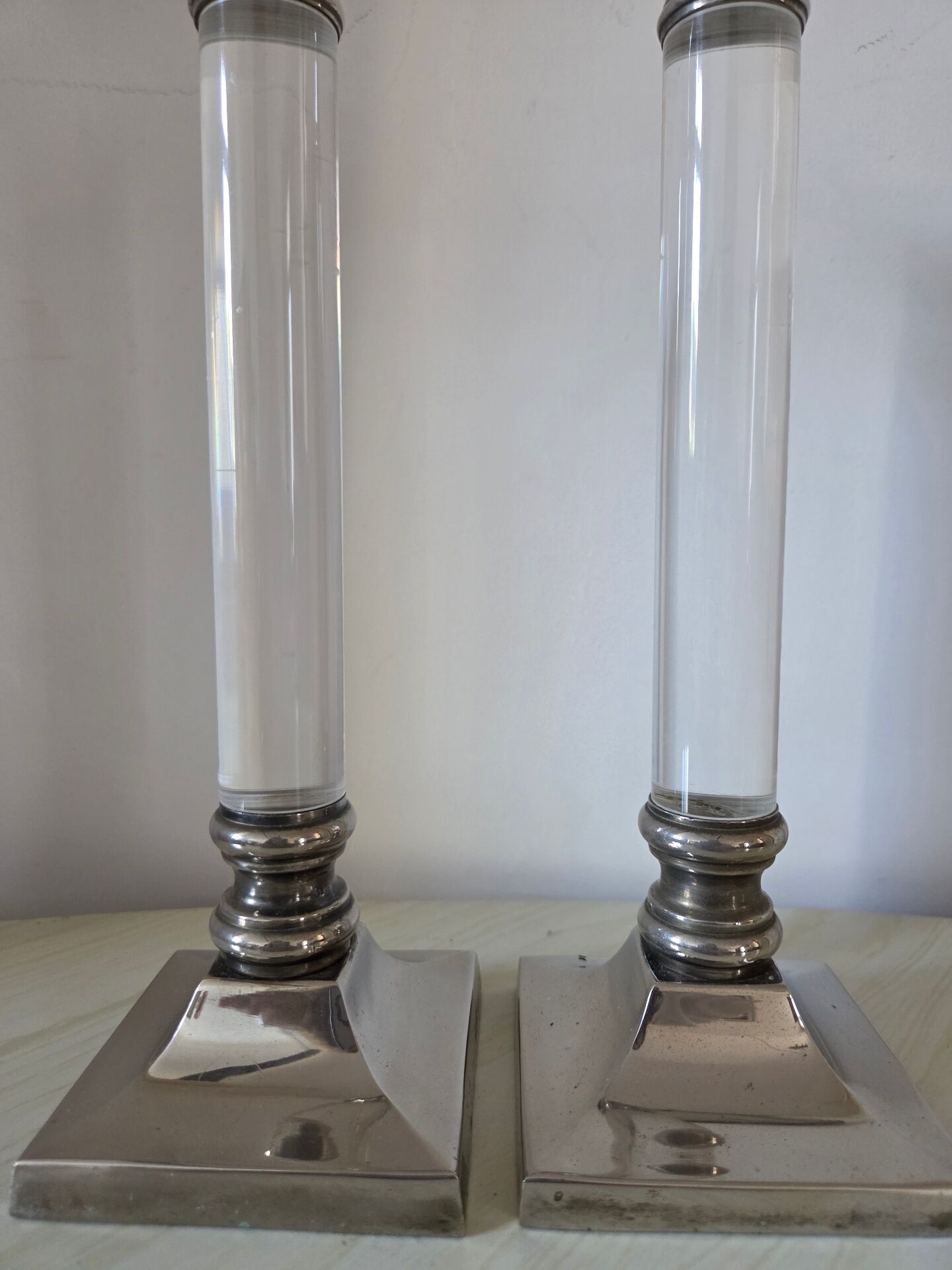Pair of lucite and silver-plated candlesticks