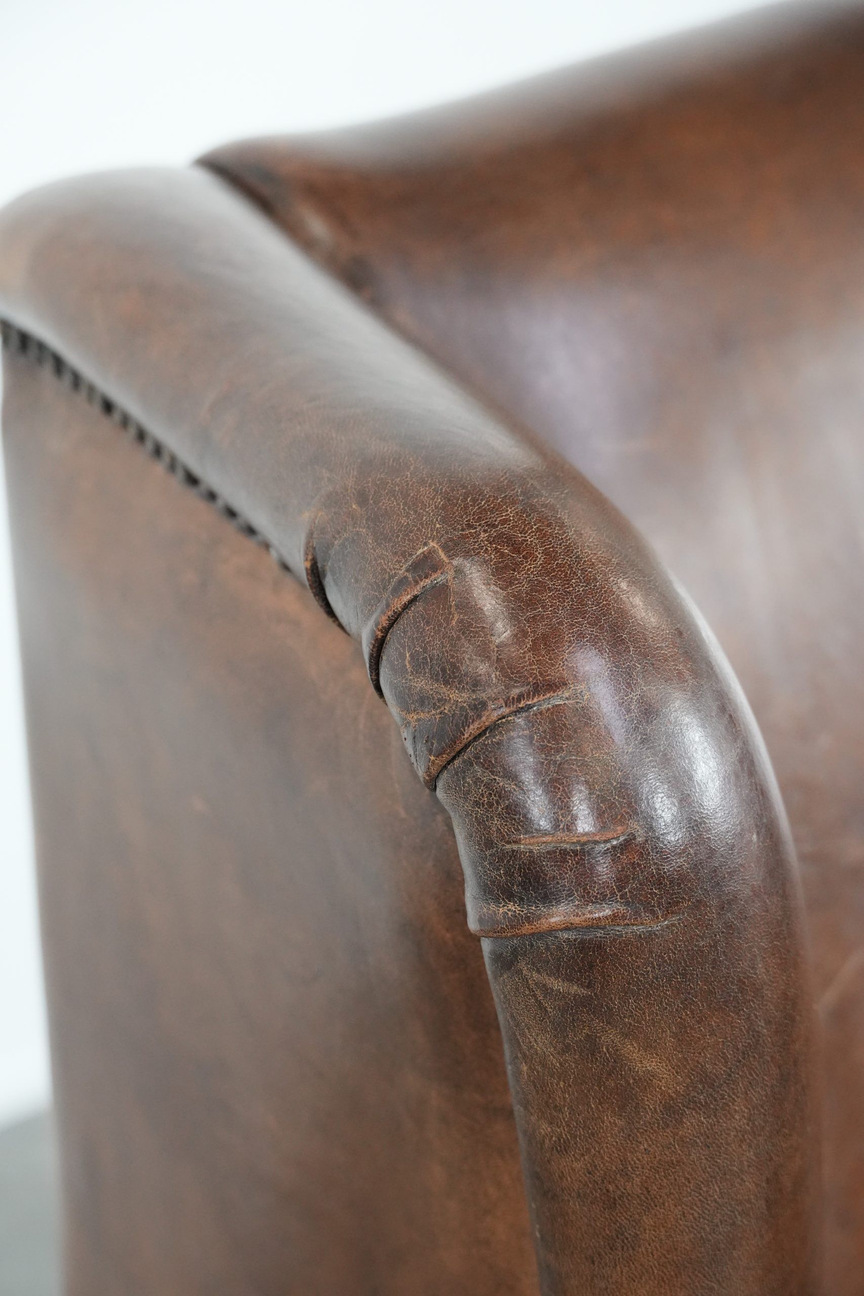 Vintage wingback armchair made of sheepskin leather with beautiful colours