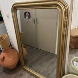 Antique gilded mirror in old Louis Philippe wood