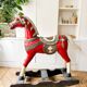 Large decorative rocking horse made of carved and hand-painted wood.