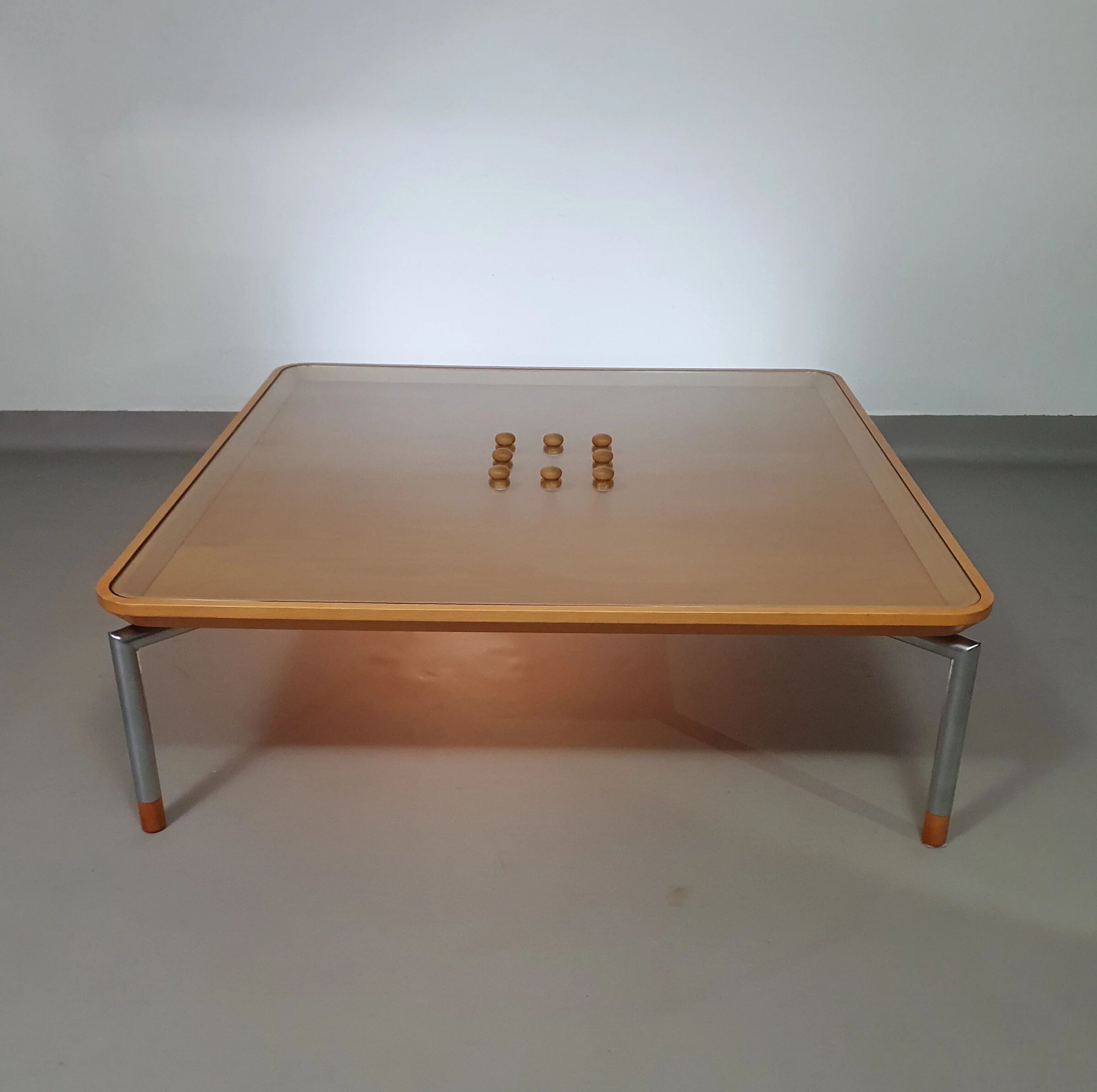Rare coffee table 110 x 110 x height 35 cm with 8 flange wooden / cork caps in the glass top.