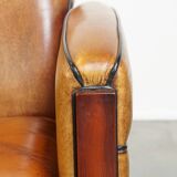 Sheepskin Art Deco design armchair with beautiful wooden details and black piping