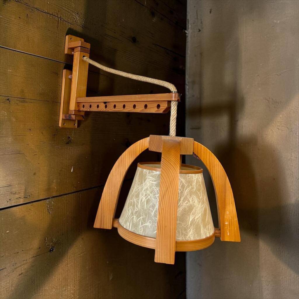 Vintage wooden wall lamp with rope detail.