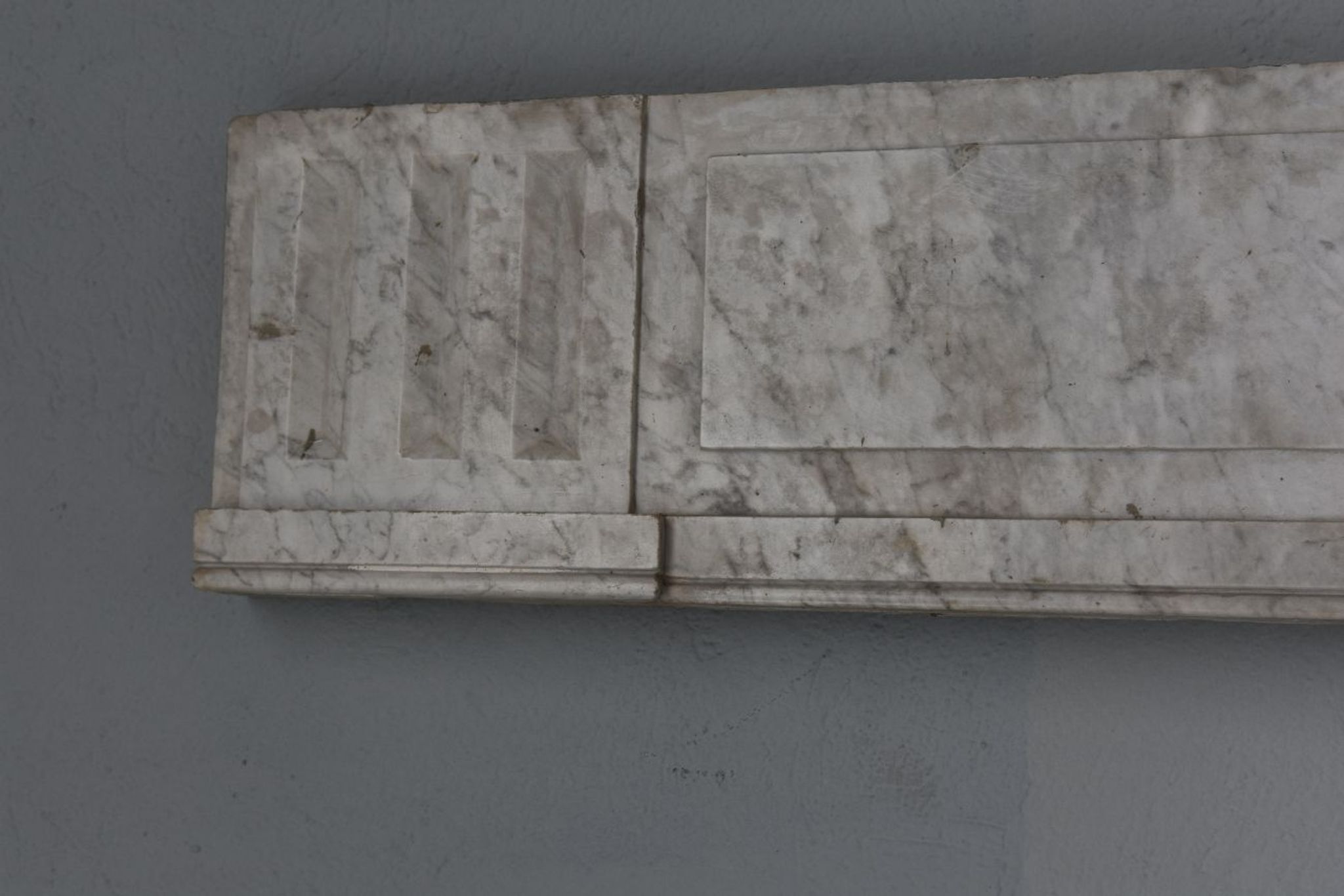 Old fireplace in white marble veined Louis XVI