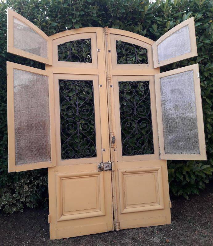 19th century double arched entrance door in oak with grilles and old glass