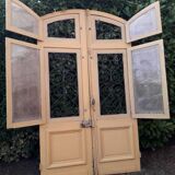 Porte d'entrée cintrée double en chêne, grilles et verre, XIXème