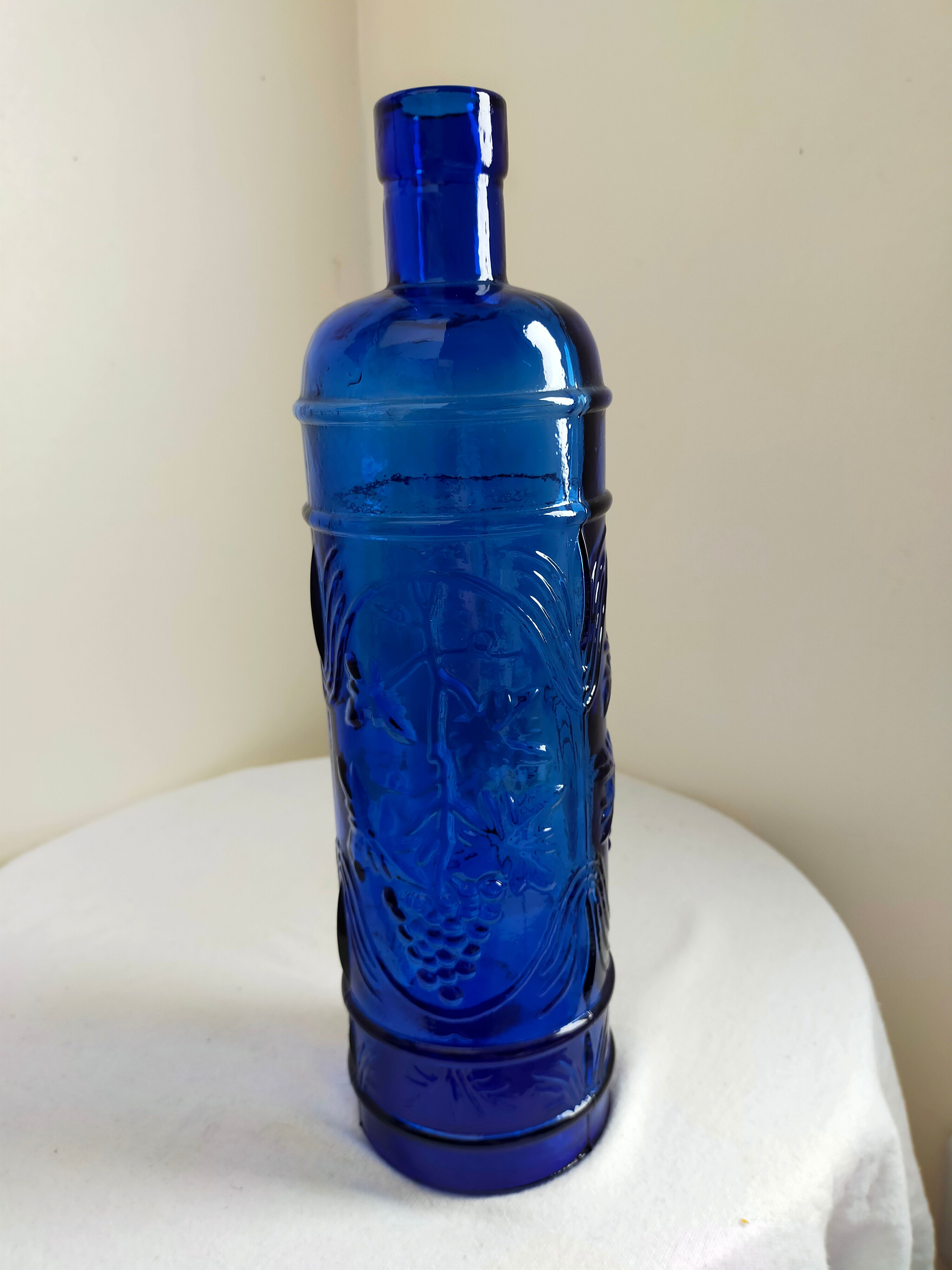 cobalt blue molded glass bottle in relief decoration bunches of grapes