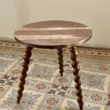 Vintage circular side table in wood with turned legs.