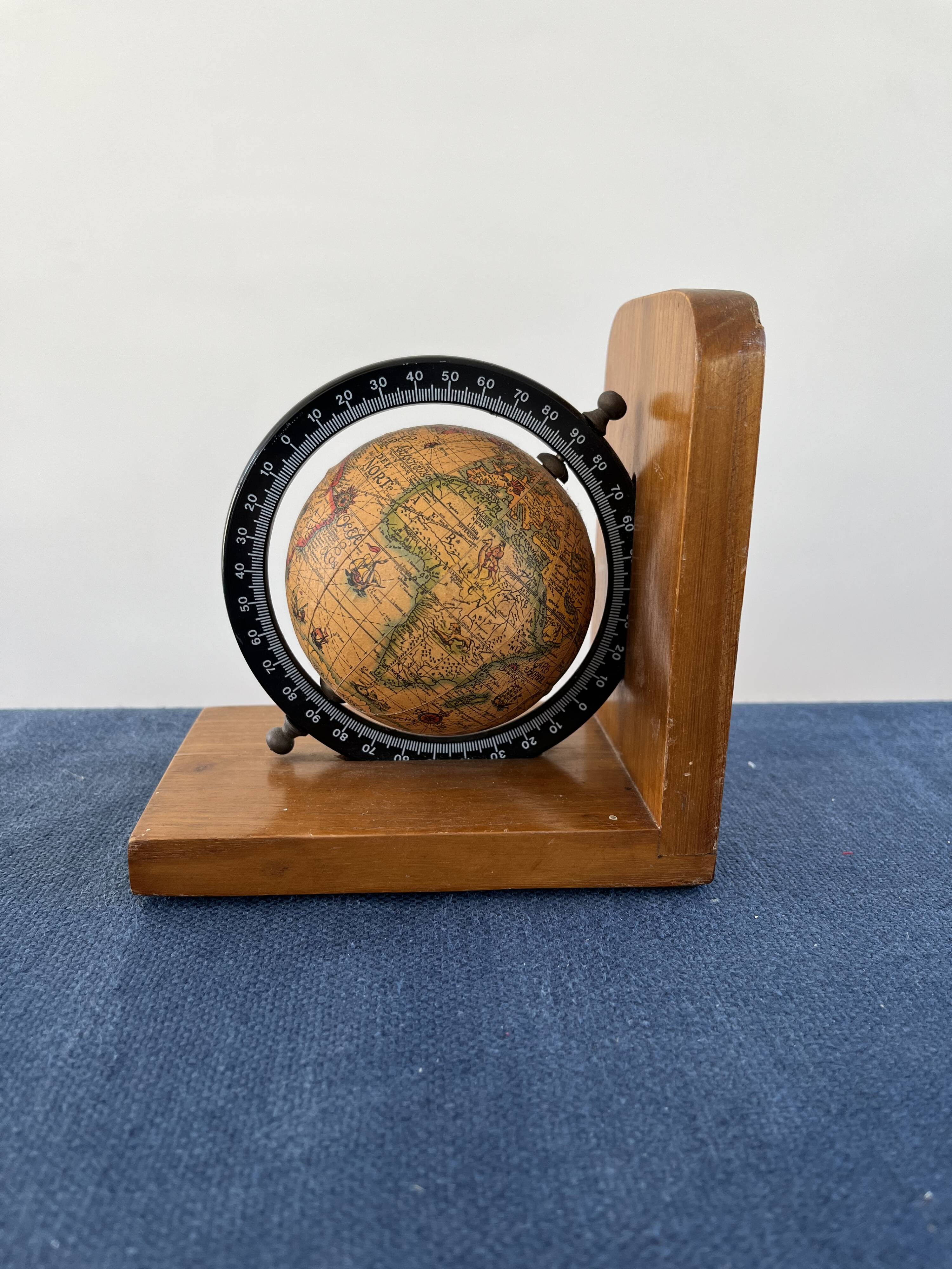 Rotating globe bookends on wooden base
