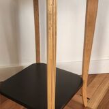 Black lacquered wooden side table with offset tops.