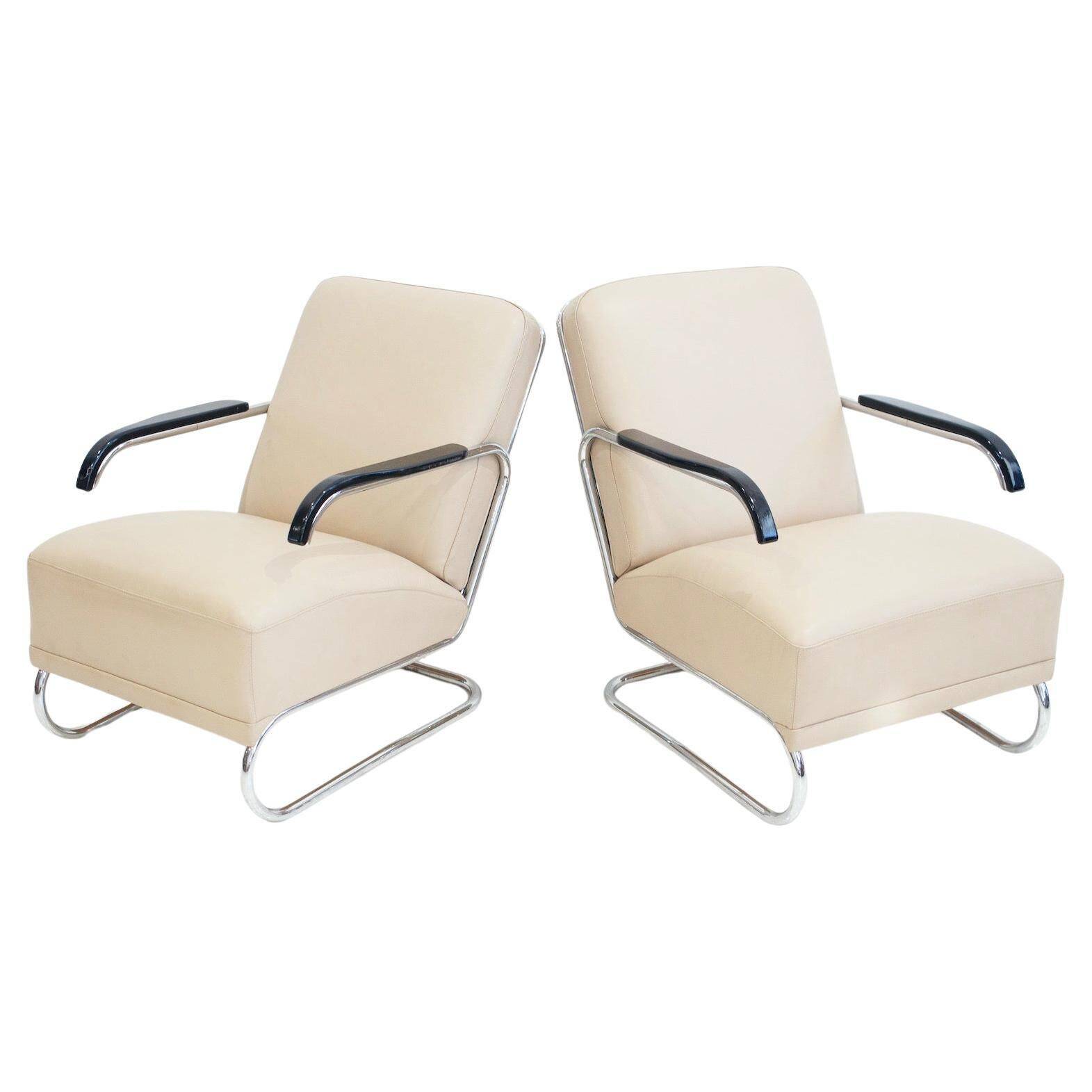 Pair of beige leather and tubular steel armchairs.