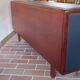Teak enfilade, sliding doors, black faux leather top, 1970s.