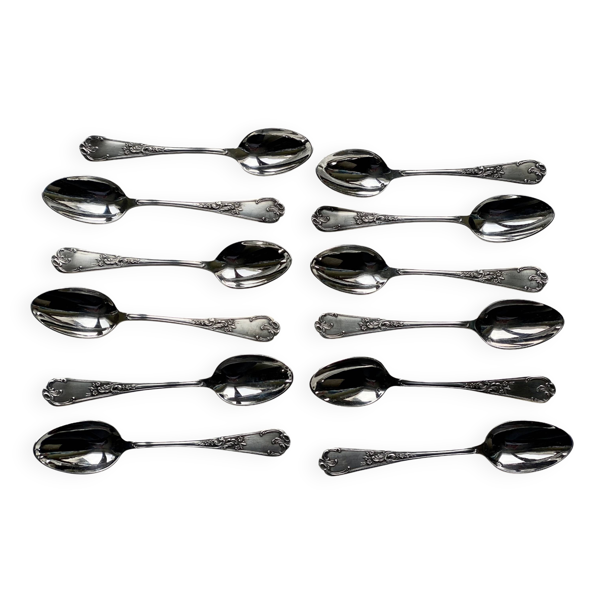 Set of 12 small silver-plated metal spoons in Art Nouveau style.