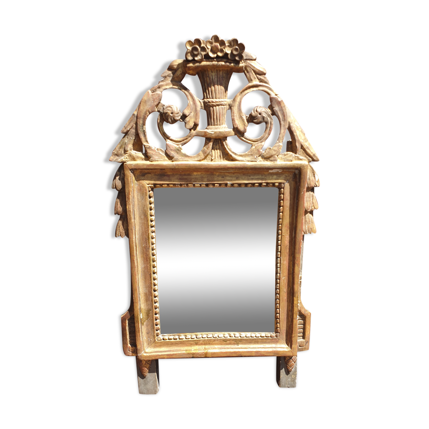 Old mirror in carved and gilded wood