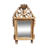 Old mirror in carved and gilded wood