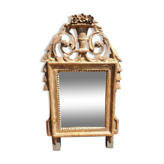 Old mirror in carved and gilded wood