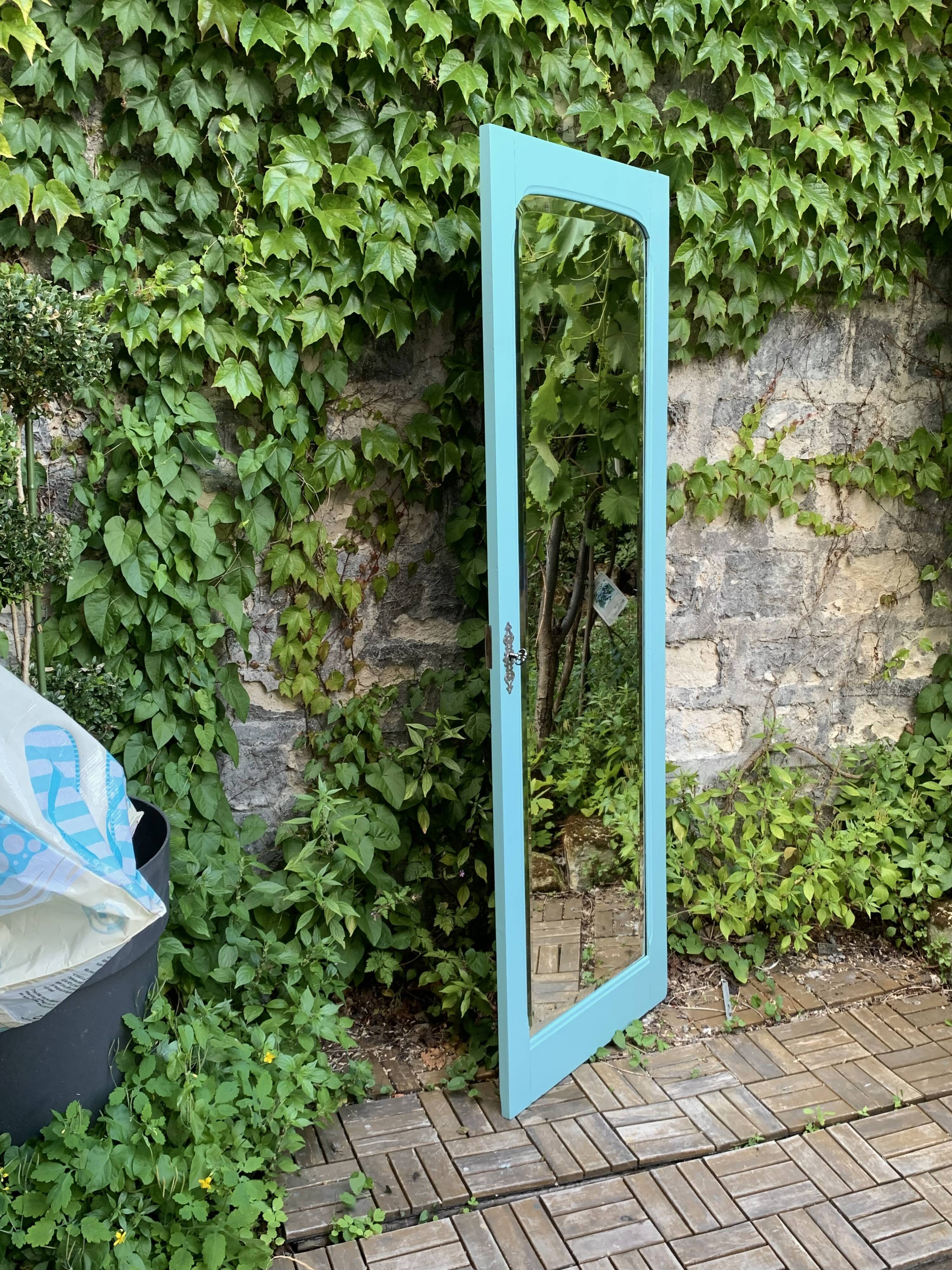Beveled mirror on turquoise Parisian door