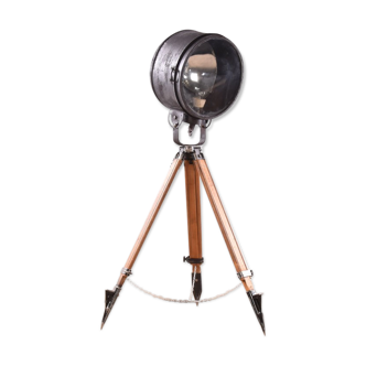 Old industrial spot on wooden tripod