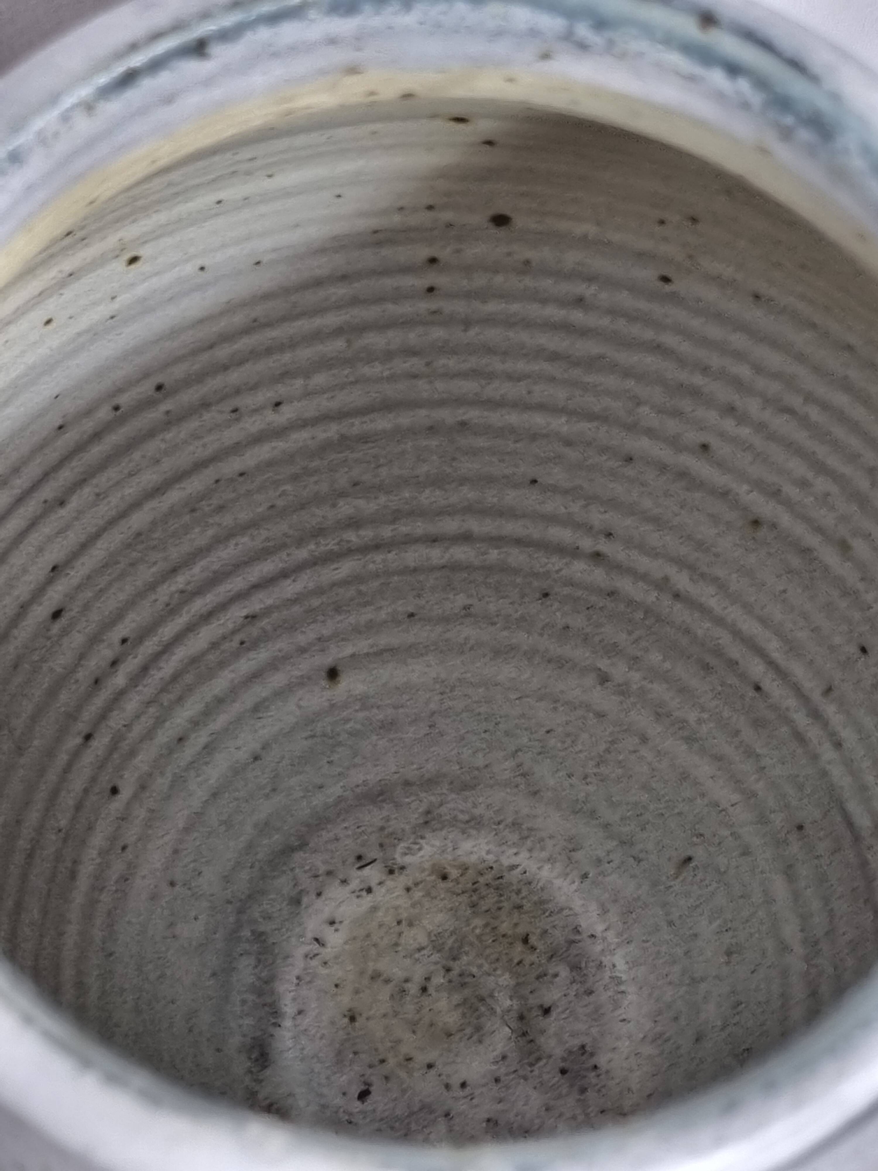 Stoneware vase signed by Sylvie Dufour, incised decoration and relief medallions, 28 cm.